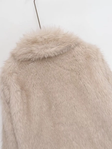 Detail of soft off-white faux fur texture and collar design on a thick winter jacket