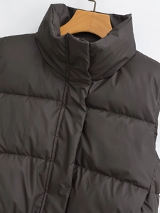 Detailed view of black quilted puffer vest with stand collar and matte waterproof fabric