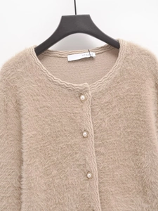 Close-up of oatmeal knit cardigan featuring soft faux mink texture and pearl buttons