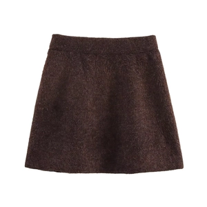 Détail d'une mini-jupe en maille marron avec texture pelucheuse et taille élastique
