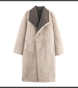 Detail of faux fur coat showing beige long-pile texture and contrast grey lapel