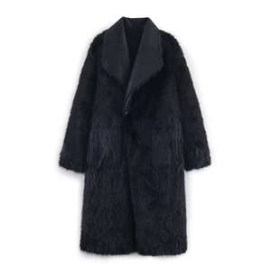 Detail of black faux fur long coat with contrast matte leather lapels and thick texture