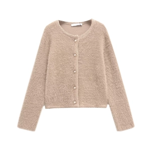 Close-up of faux mink knit cardigan featuring pearl buttons and wavy edge detailing