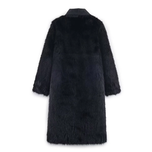 Detail view of the plush faux fur texture and leather collar patchwork on the black coat