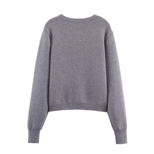 Detail view of the ribbed knit hem and texture on a grey long sleeve cardigan