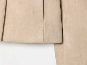 Close-up of precise stitching and premium khaki suede fabric on this stylish blazer