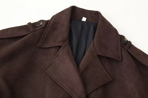 Detail view of brown suede coat with wide lapels, shoulder straps and satin lining