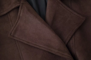 Detailed view of the dark brown faux suede collar and precise stitching on the jacket
