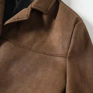 Close-up of brown suede jacket collar and shoulder with decorative stitching detail