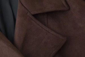 Detail of dark brown faux suede coat collar with double stitching and soft inner lining