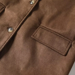 Detailed macro view of brown suede jacket with marble buttons and premium stitching