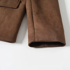 Close-up of the suede texture and stitching on the brown blazer cuff