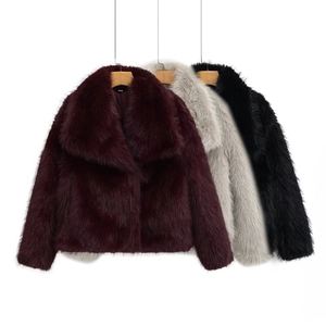 Detailed view of faux fur coats in burgundy, grey, and black with large collars