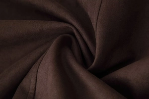 Close-up of premium dark brown suede fabric texture with soft fiber details