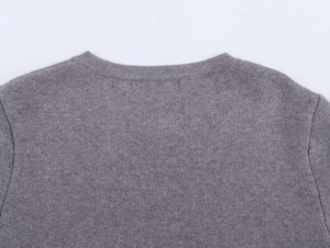 Detail view of ribbed round neckline on a gray knitted long sleeve cardigan sweater