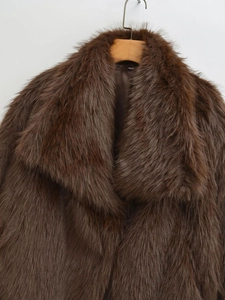 Close-up of deep brown faux fur coat showing dense texture and large lapel collar