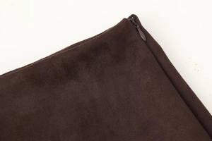 Detail of dark brown suede skirt featuring a matching color invisible zipper closure