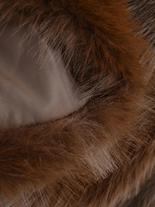 Close-up of brown faux fur texture and smooth silky inner lining of the winter coat