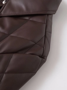 Macro view of brown quilted PU leather jacket showing detailed texture and stitching