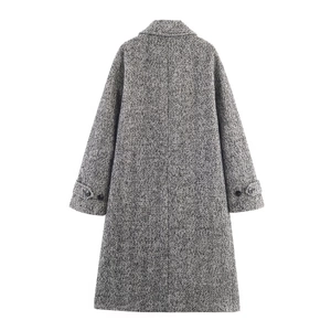 Back view of long herringbone wool coat showing belt cuffs and classic H-line cut