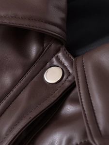 Close-up of premium brown faux leather texture with sleek silver metal snap button