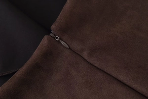 Close-up of invisible zipper detail on premium dark brown faux suede fabric skirt