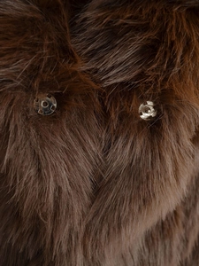 Close-up of brown faux fur texture with silver metal snap buttons for secure closure