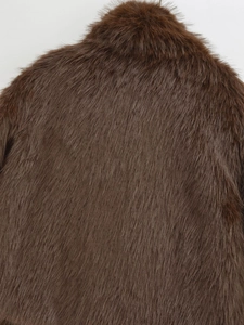 Close-up of the plush brown faux fur texture and lapel collar on the winter coat