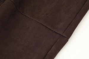 Macro shot of dark brown faux suede fabric with precise stitching details for women set