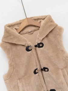 Détail de gilet à capuche en fausse fourrure avec texture polaire et fermoirs métalliques