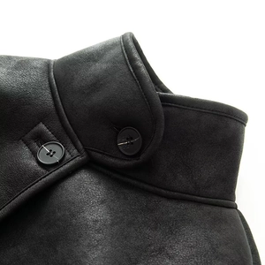 Detail of high stand collar and resin buttons on black faux suede jacket