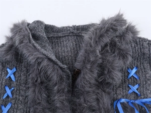 Detail of grey knit sweater with faux fur collar and blue lace-up ribbon accents