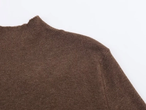 Detailed macro view of brown mock neck knit top featuring fine vertical ribbed texture