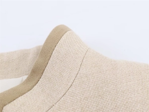 Detailed view of beige jacket collar with premium khaki trim and fine twill texture