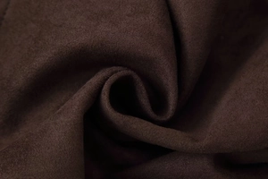 Macro shot of dark brown faux suede fabric showing rich velvety texture and soft fiber details