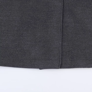 Close-up of charcoal grey wool fabric showing high-quality twill texture and stitching