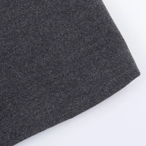 Macro view of dark gray twill wool blend fabric showing thick texture and fine fibers