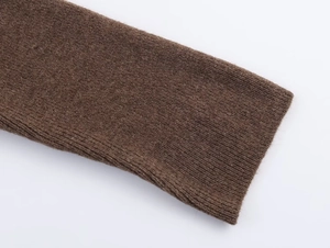 Close-up of the brown ribbed knit cuff showing fine vertical texture and elasticity