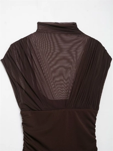 Detail of dark brown mock neck top with sheer mesh V-paneling and elegant side ruching