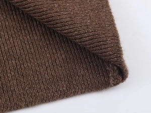 Close-up of deep brown rib-knitted fabric texture showing thick vertical elastic weave