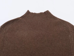 Detail view of coffee brown knit sweater featuring a mock neck and ribbed texture knitwear