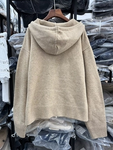 Back view of a beige knitted zip-up hoodie featuring ribbed cuffs and drop shoulders