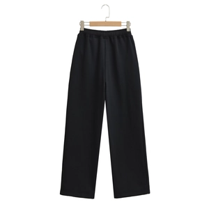 Detail of black wide-leg joggers featuring a flexible elastic waist and thick fabric