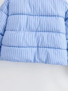 Detailed view of light blue striped quilted jacket featuring horizontal padded stitching