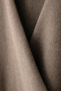 Detailed close-up of premium dark brown wool fabric texture with soft fiber finish