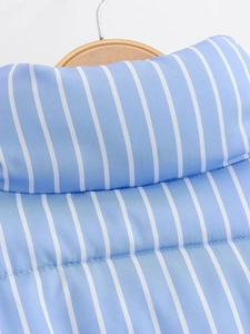 Detail of blue and white striped quilted jacket collar on a wooden hanger texture