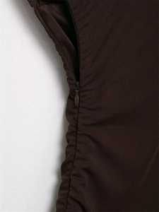 Detail shot of a dark brown dress featuring a hidden zipper and fine ruching craftsmanship