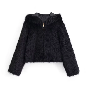 Detail shot of the golden zipper on a black faux fur hooded jacket with soft fluffy texture