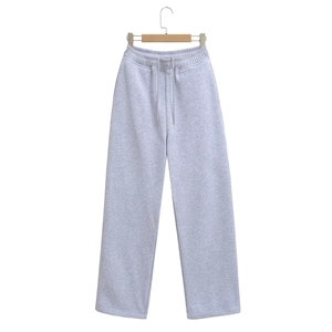Detail of light gray drawstring sweatpants with elastic waistband and straight leg cut
