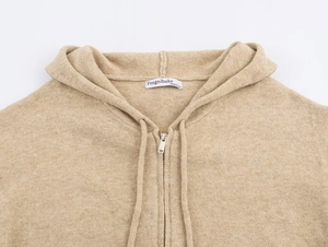 Detailed view of khaki knit hoodie texture with metal zipper and adjustable drawstrings